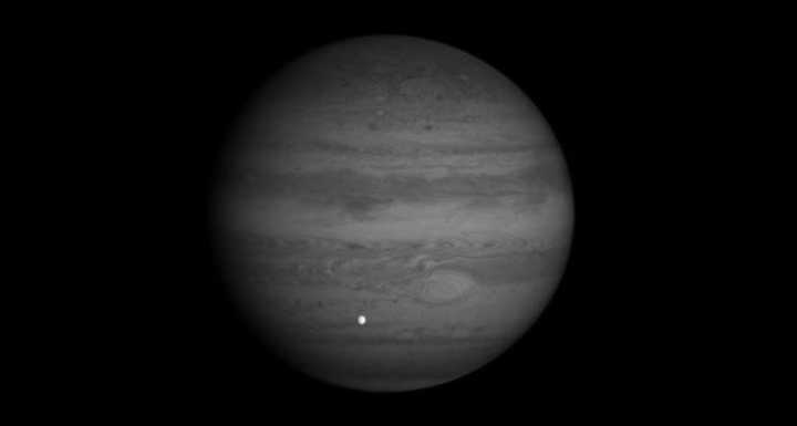 This image, taken by NASA’s Cassini spacecraft, shows Jupiter in a near-infrared wavelength, and Europa, one of Jupiter’s largest moons, passing across. Credit: NASA/JPL/University of Arizona. Picture of Jupiter and Europa, one of its moons.